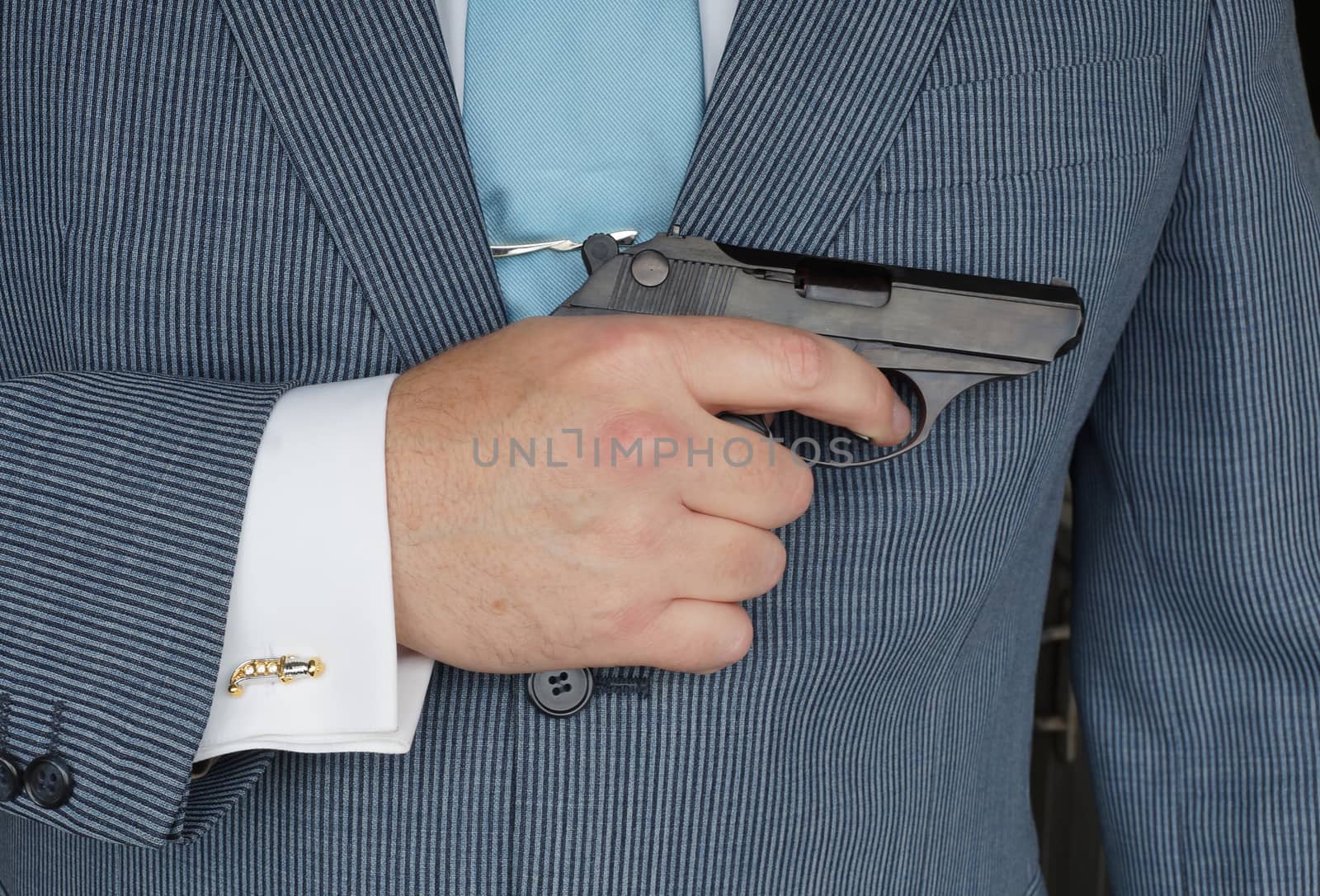 The businessman with the gun, as allegory of rigid competitiveness