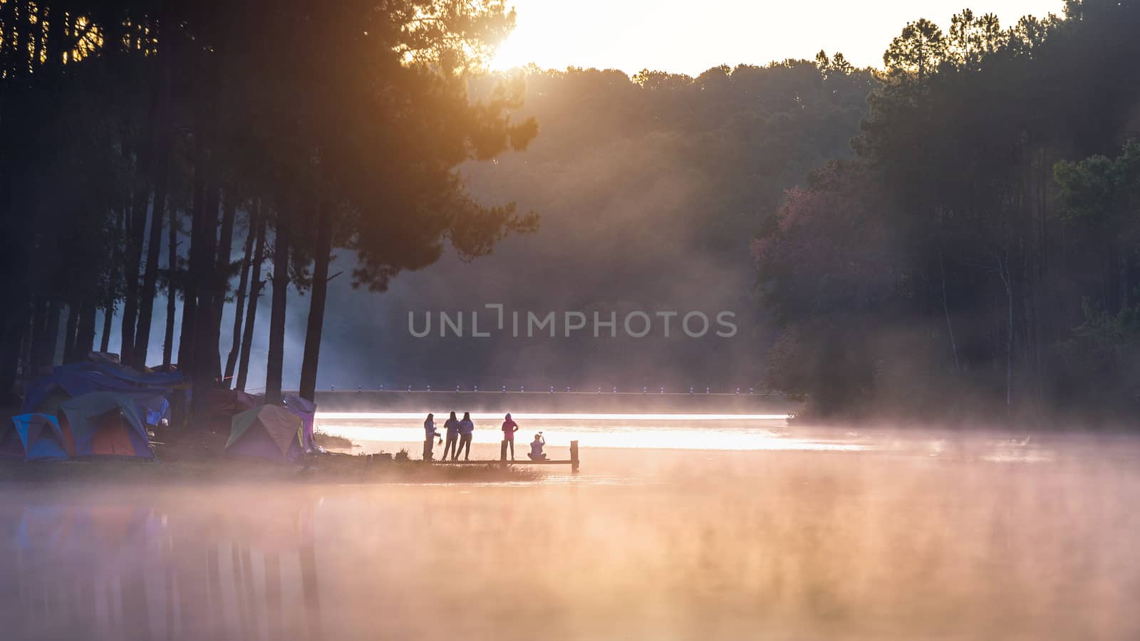 Silhouette of tourist enjoying at Pang Ung in morning, Mae Hong Son in Thailand. by gutarphotoghaphy