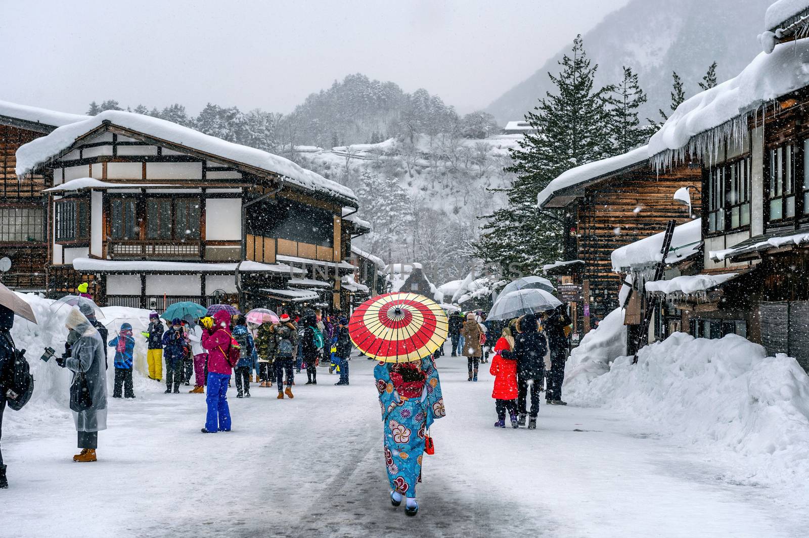 Asian woman wearing japanese traditional kimono at Shirakawa-go village in winter, UNESCO world heritage sites, Japan.