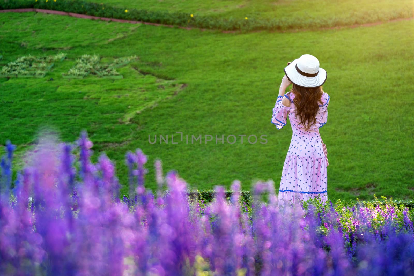 Beautiful woman on a flower garden. by gutarphotoghaphy
