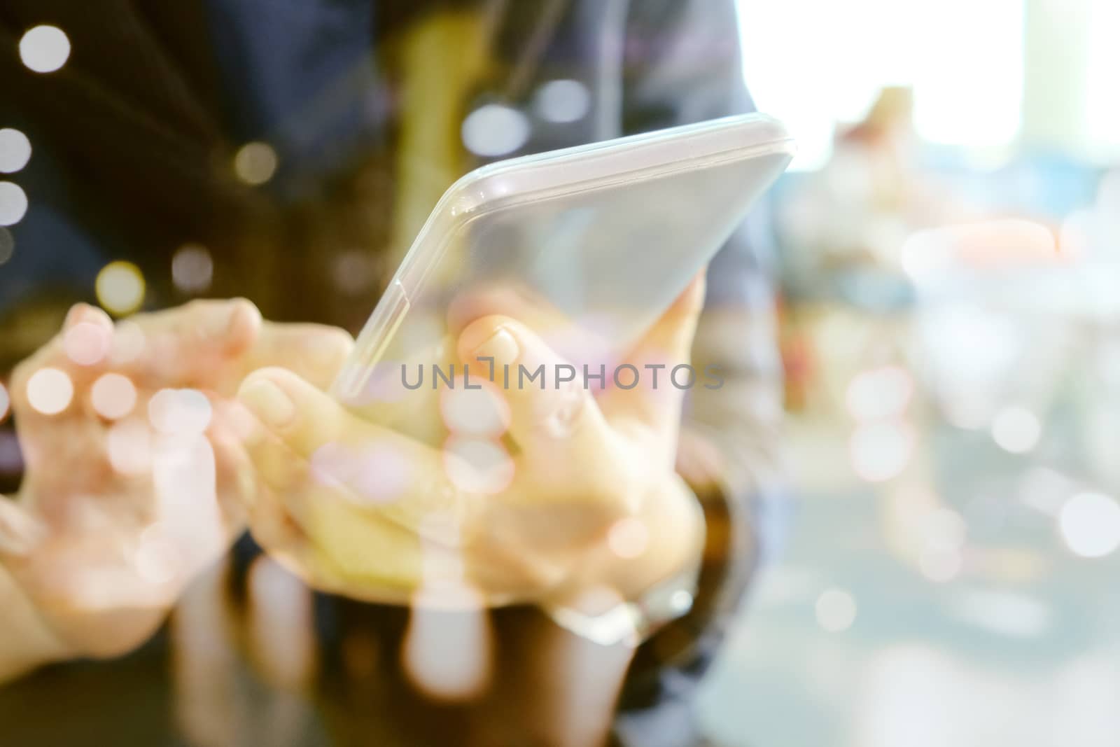 Double exposure of Phone on hands.