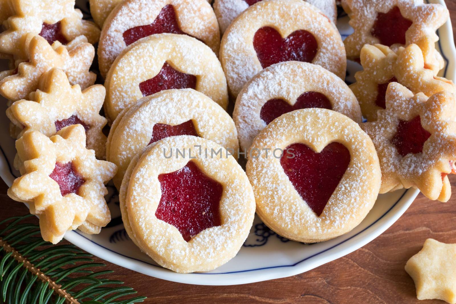 Linzer Christmas cookies on a plate on a wooden table by madeleine_steinbach