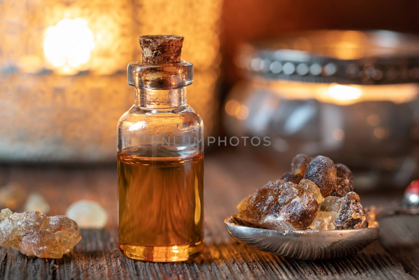 A bottle of frankincense essential oil with frankincense resin c by madeleine_steinbach