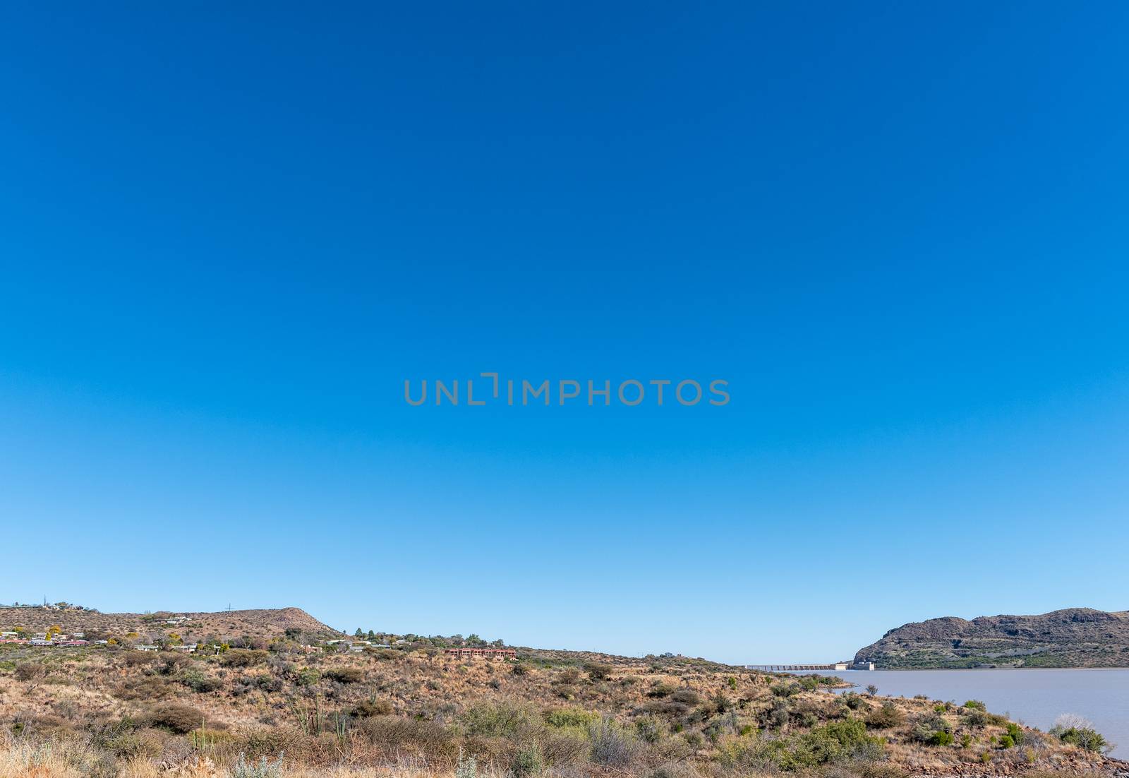 View of the the Vanderkloof town in the Northern Cape Province. The wall of the Vanderkloof Dam in the Orange River is visible in the back
