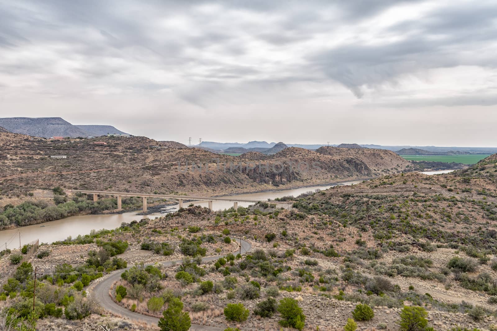 View downstream of the Vanderkloof Dam in the Orange River on the border of the Free State and Northern Cape Provinces. The single lane road bridge is visible