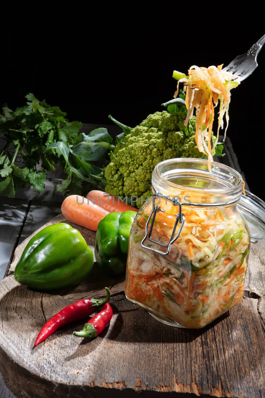 Cabbage and vegetables on an old wooden background