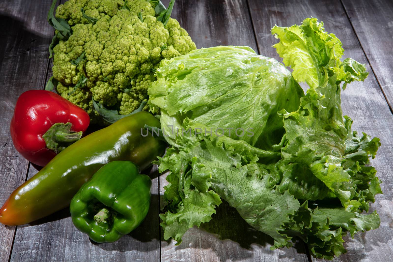 Cabbage and vegetables on an old wooden desk