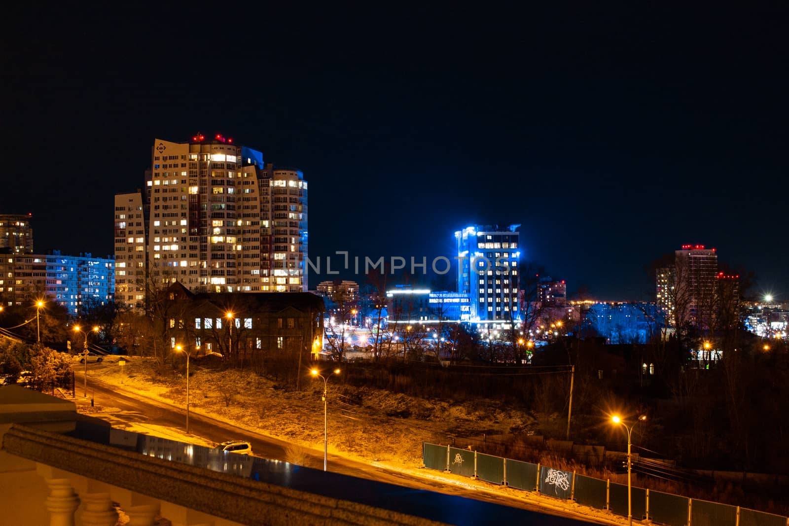 Evening view of the city of Khabarovsk in winter. Urban landscape. In the Windows of the houses light.