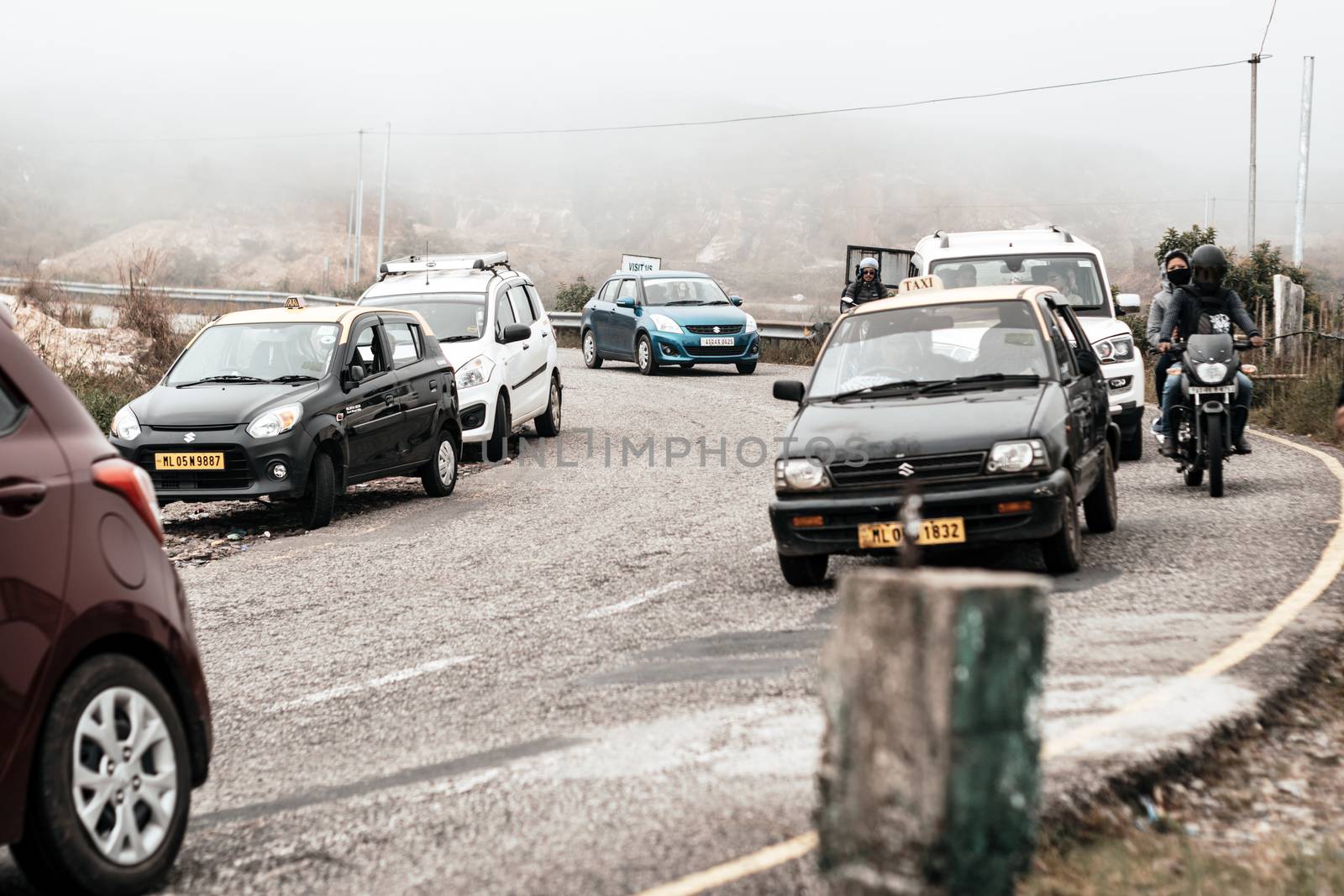 Pelling, Sikkim, India May 16 2018: Tourist vehicles lined up to climb in the step hill region of himalayan mountain valley.