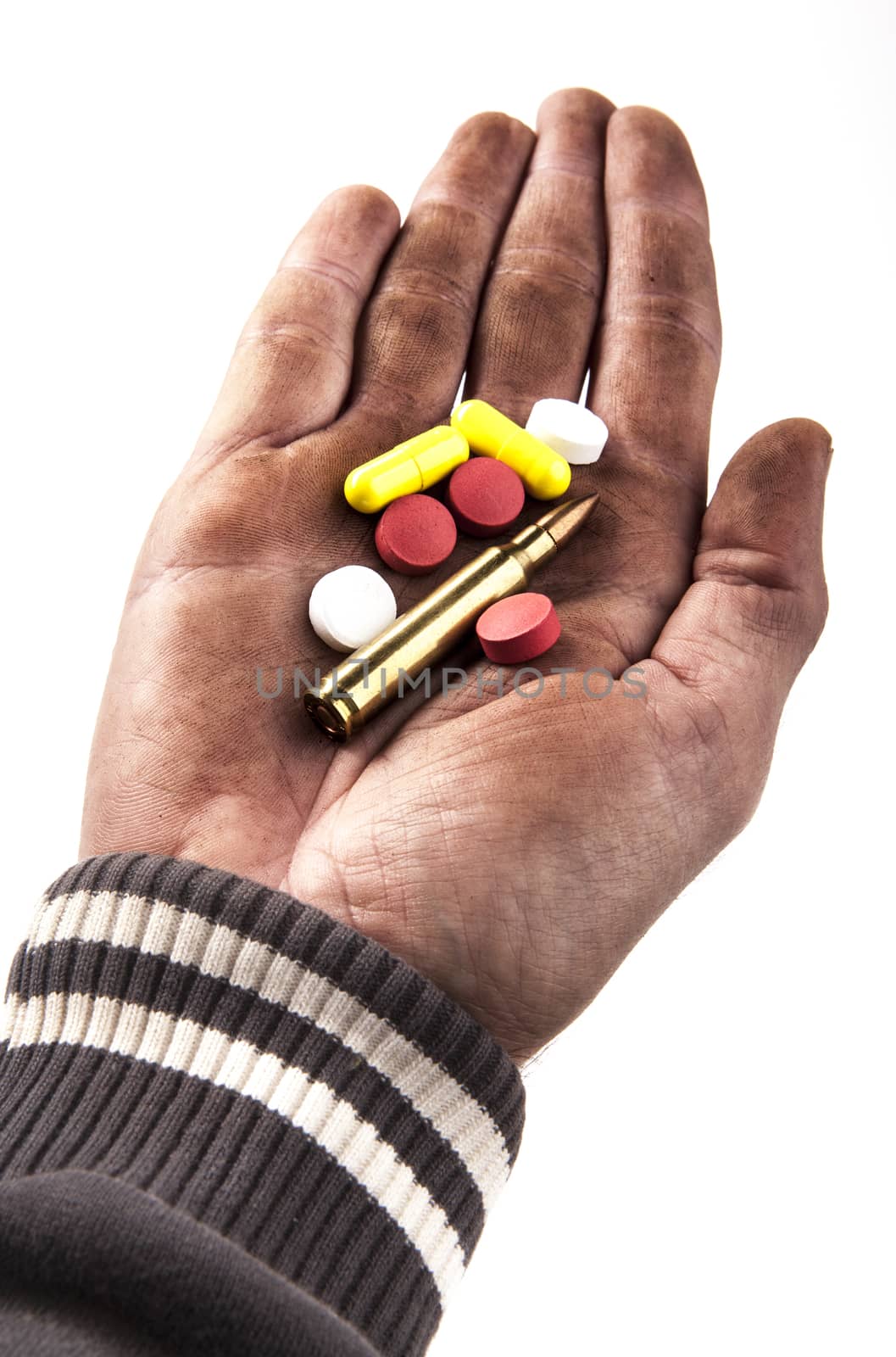 dirty human hand holding pills and bullet isolated on white background