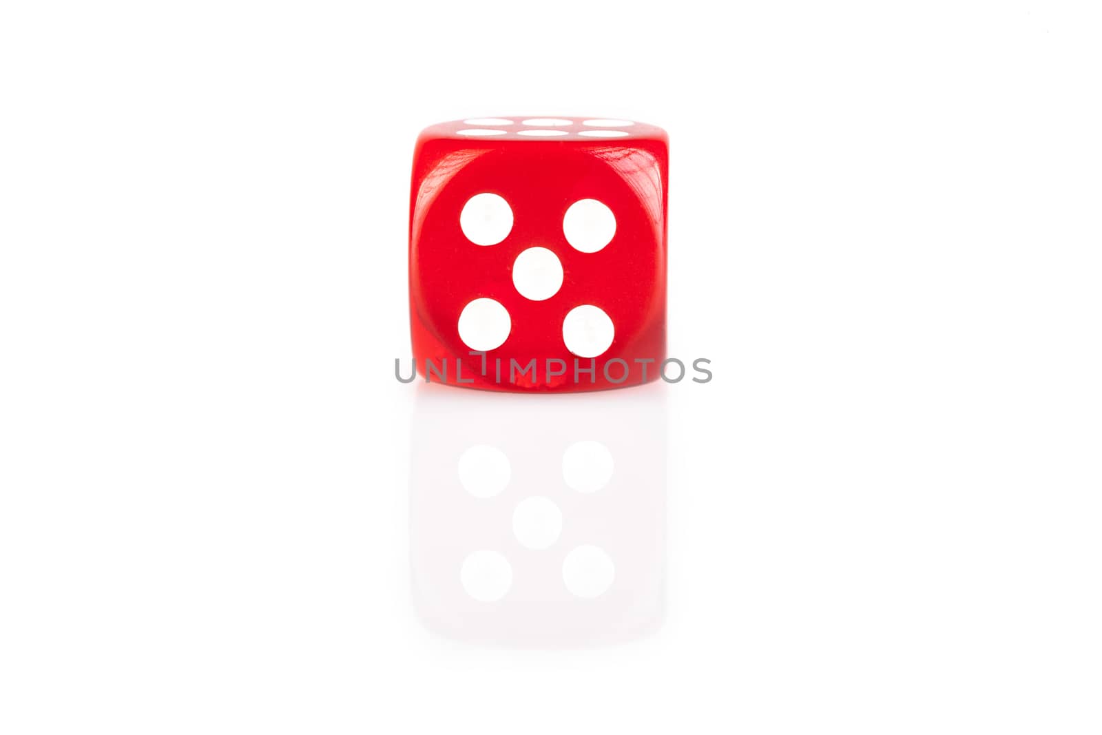 One  red dice isolated on white background with reflection