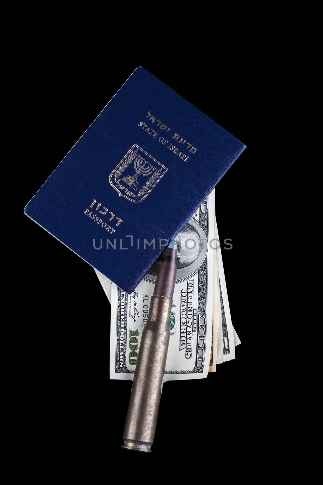 Israelian passport with dollar banknotes and a rifle bullet isolated on black background