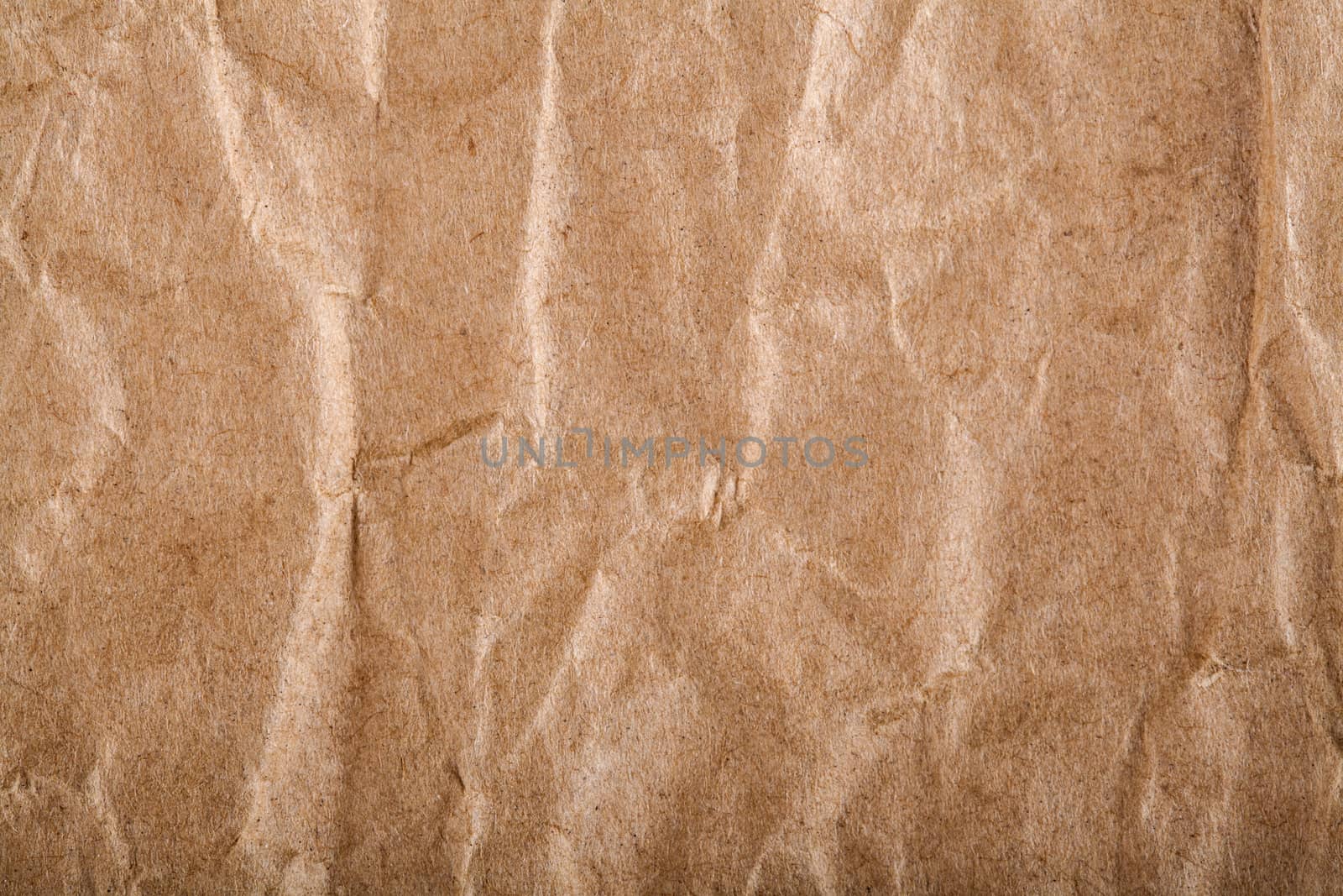 Old brown wrapping wrinkled paper closeup texture