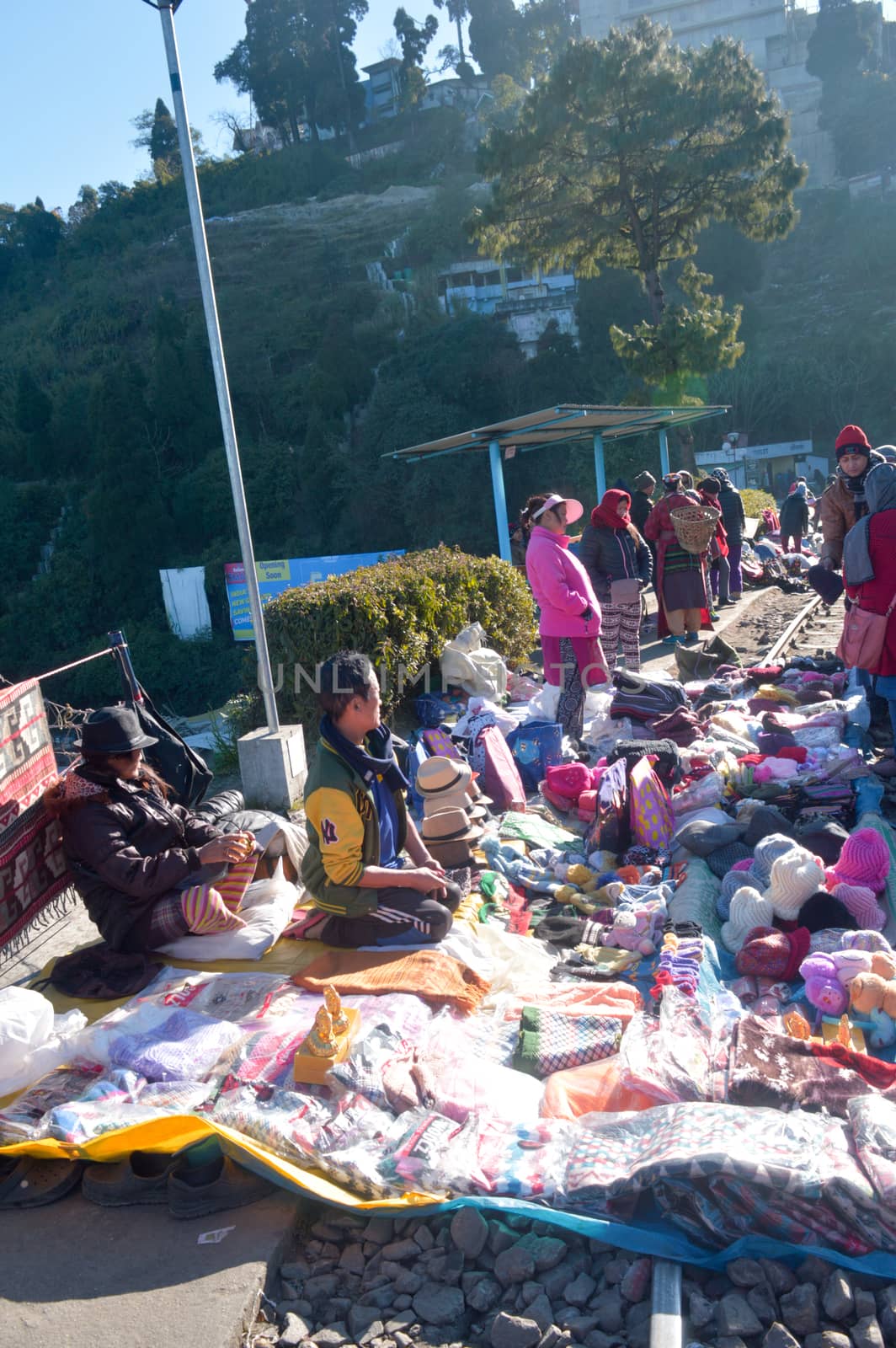 Batasia Loop, Darjeeling, 2 Jan 2019: Shopkeepers with their little makeshift stalls on the railway lines, wrap up their business with great agility and speed as the toy train arrives. by sudiptabhowmick