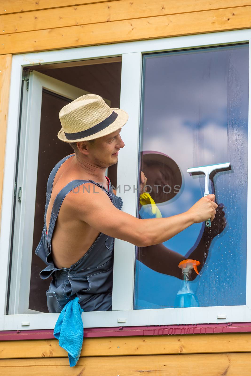 A window cleaner during work, cleaning the glass