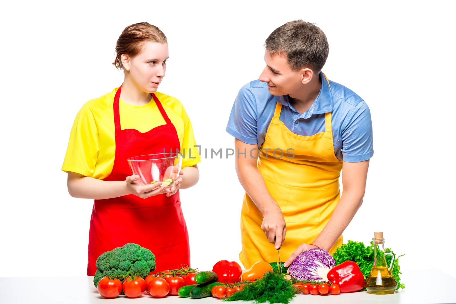 family couple preparing healthy vegetable salad, shot on white background