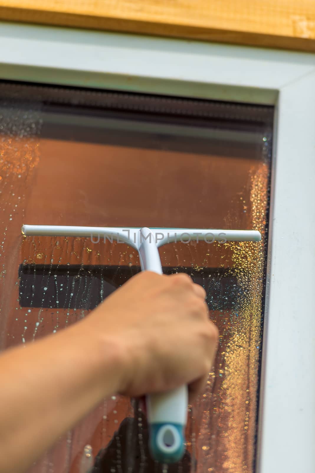 Glass cleaning tool, male hand close-up