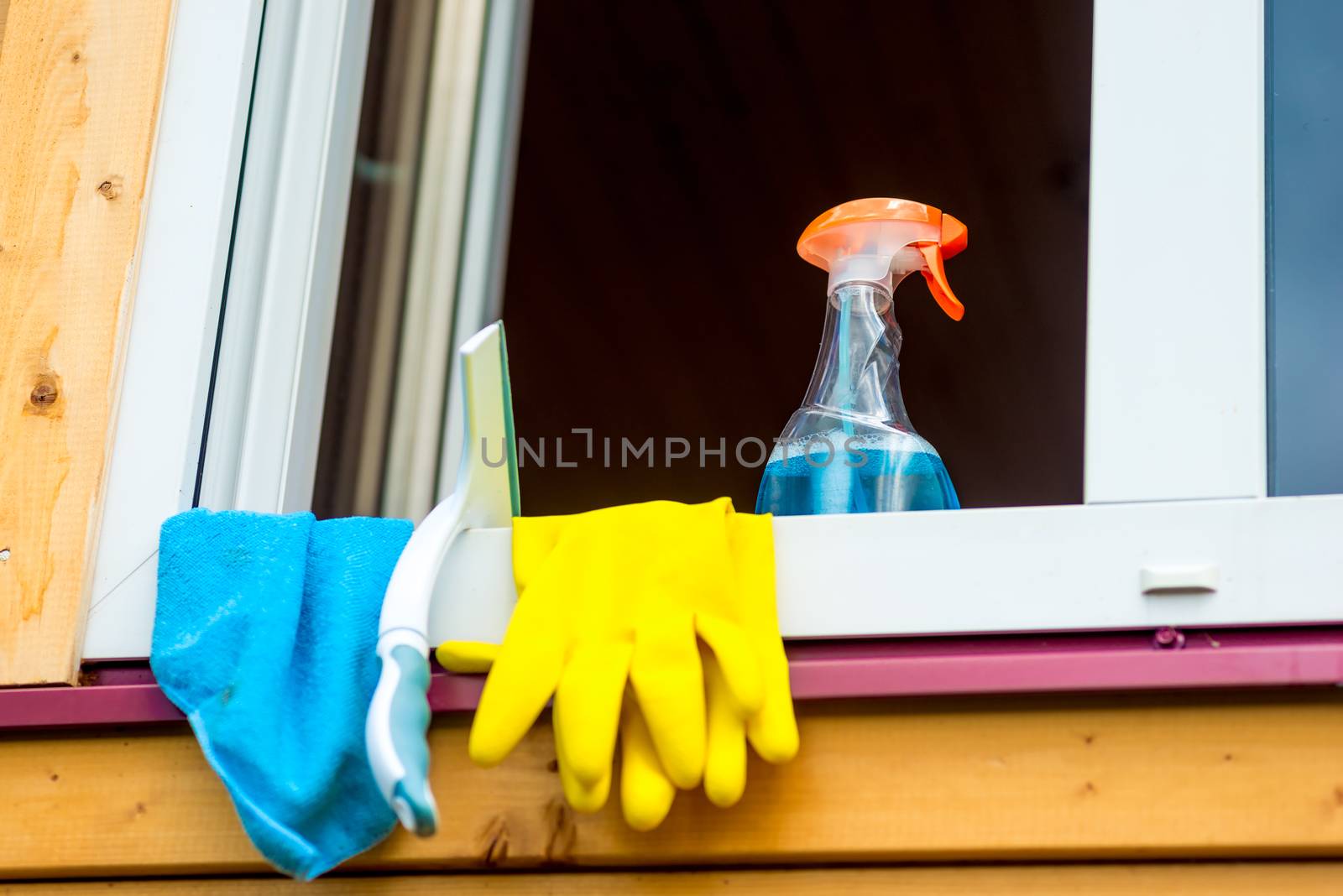window cleaning tools on window sill close up by kosmsos111