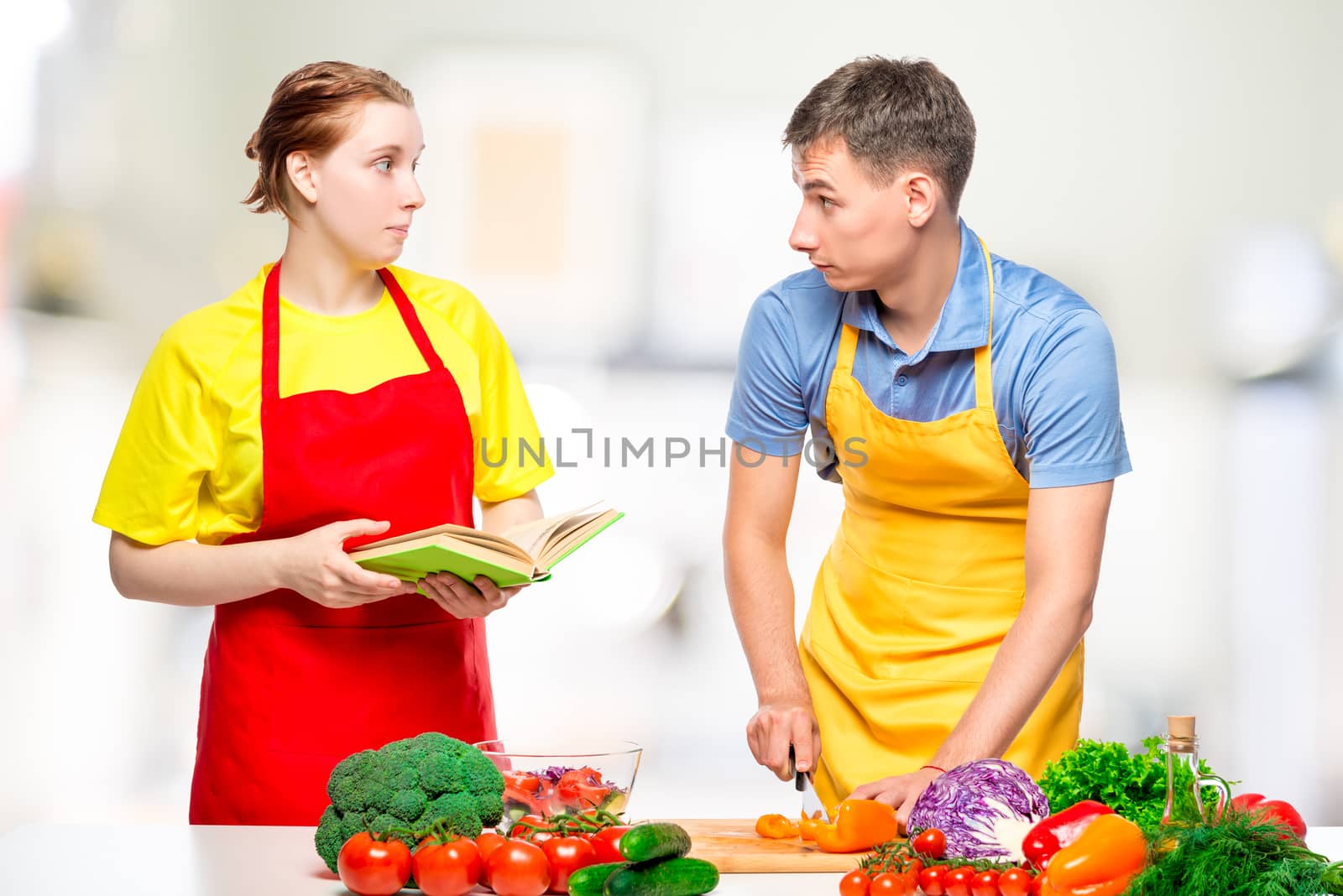 couple in the kitchen preparing fresh vegetable salad by kosmsos111