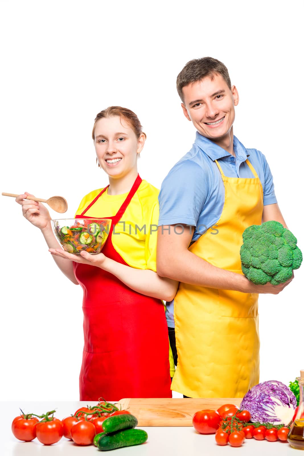 vertical portrait of a happy couple with vegetables and salad on by kosmsos111