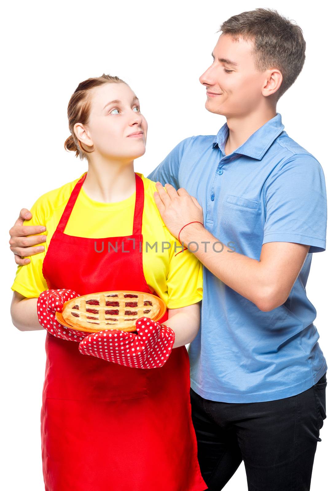 girl in an apron with a pie and her beloved husband, portrait on a white background