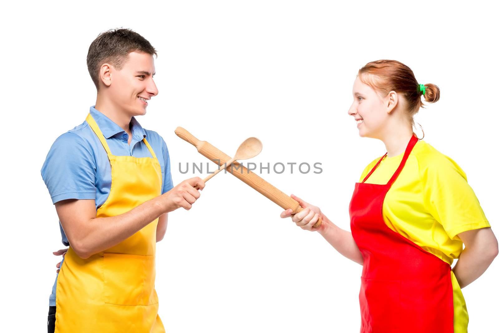 portrait of a man and a woman in an apron with kitchen utensils fighting on a white background