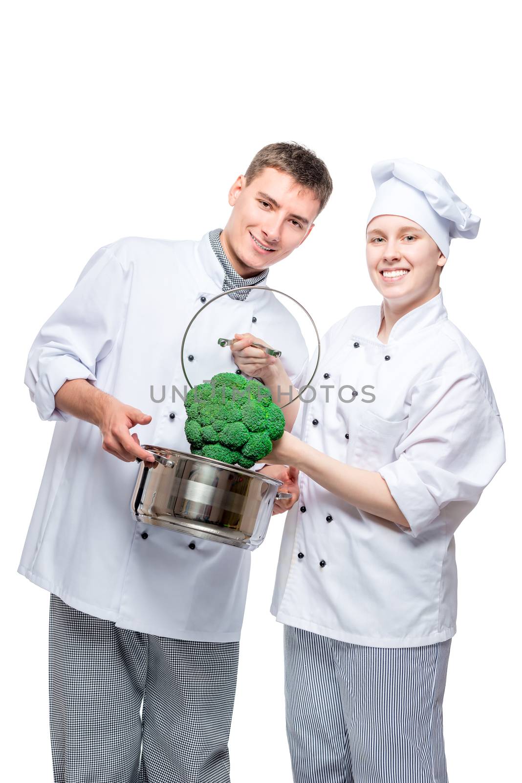 vertical portrait of fellow chefs with pan and broccoli on white background
