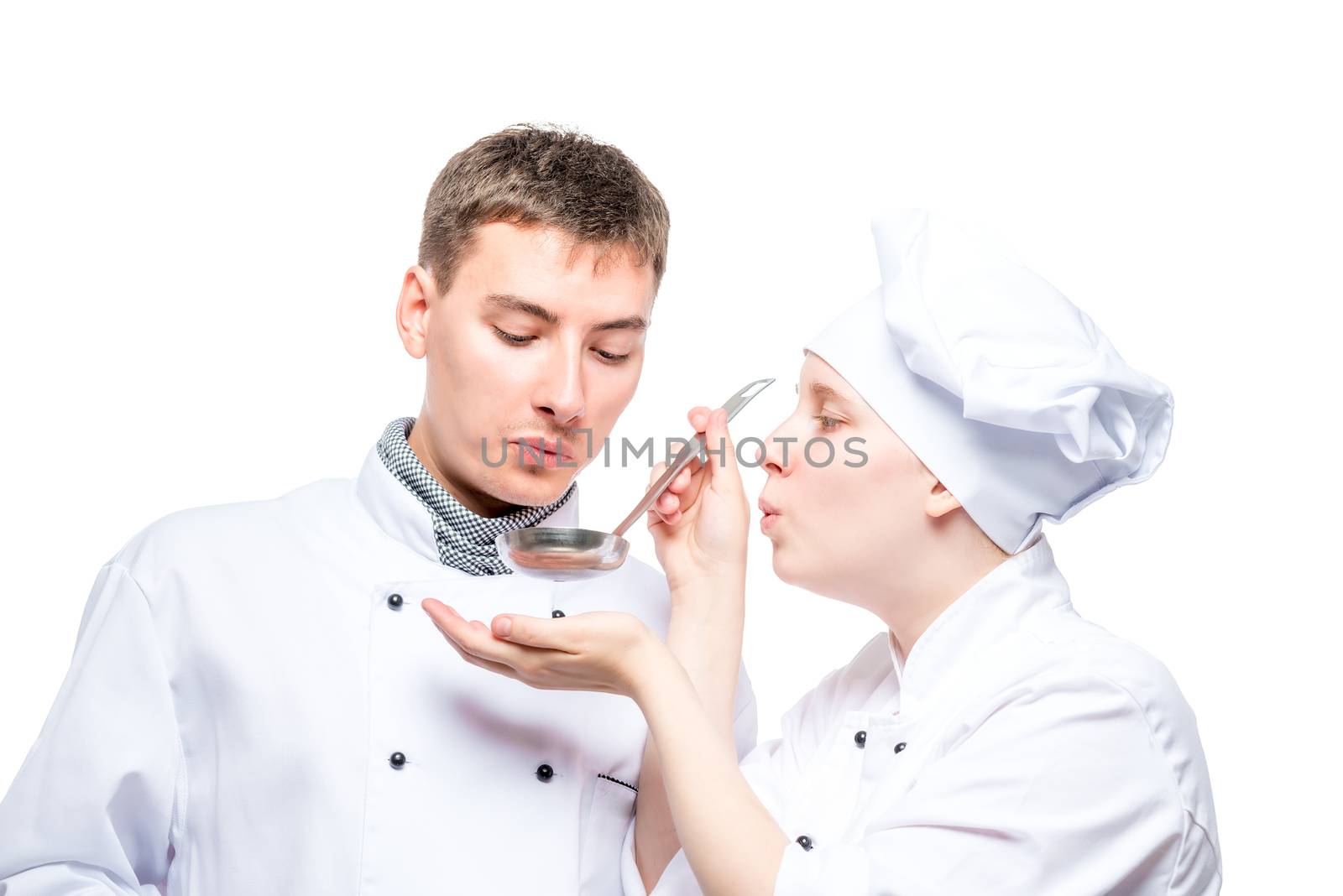 professional chefs try soup from a ladle on a white background