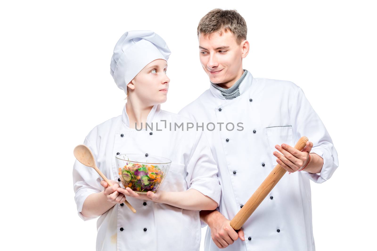 portrait of young professional chefs with a dish on a white back by kosmsos111