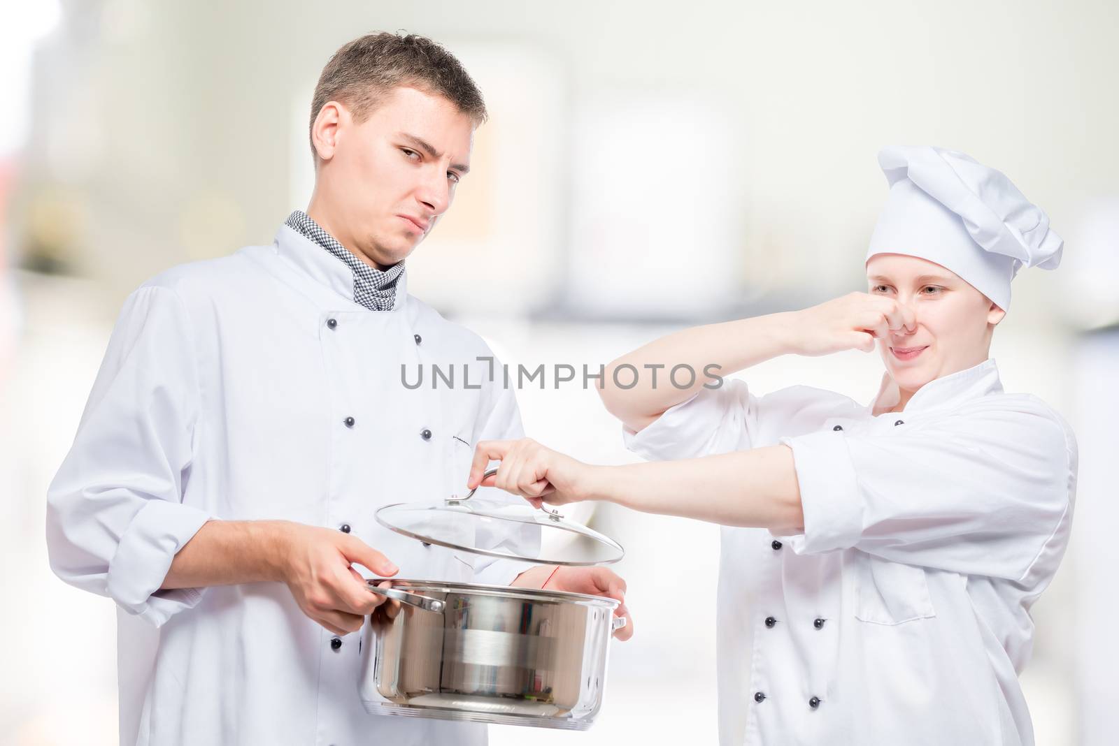 Concept photo - cooks and foul soup in a pan, shooting on the background of the kitchen