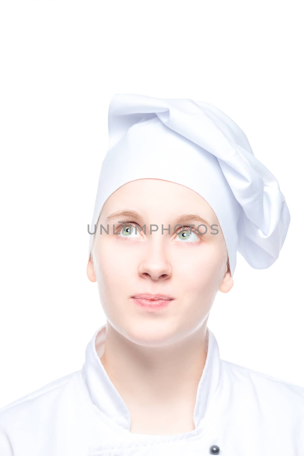 girl cook in cap looks up, portrait is isolated on white background