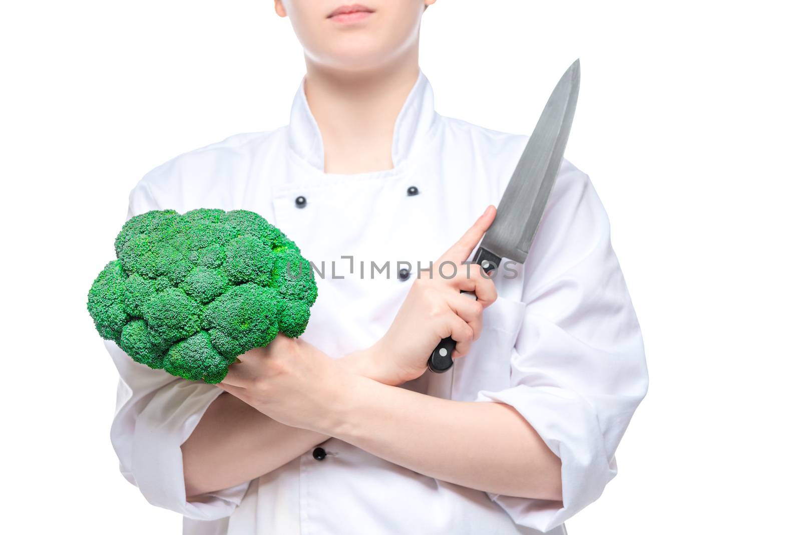 broccoli and a sharp knife in the hands of the cook close-up on by kosmsos111