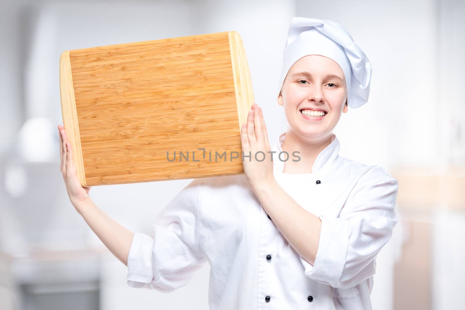 chef cook with wooden cutting board posing in the kitchen