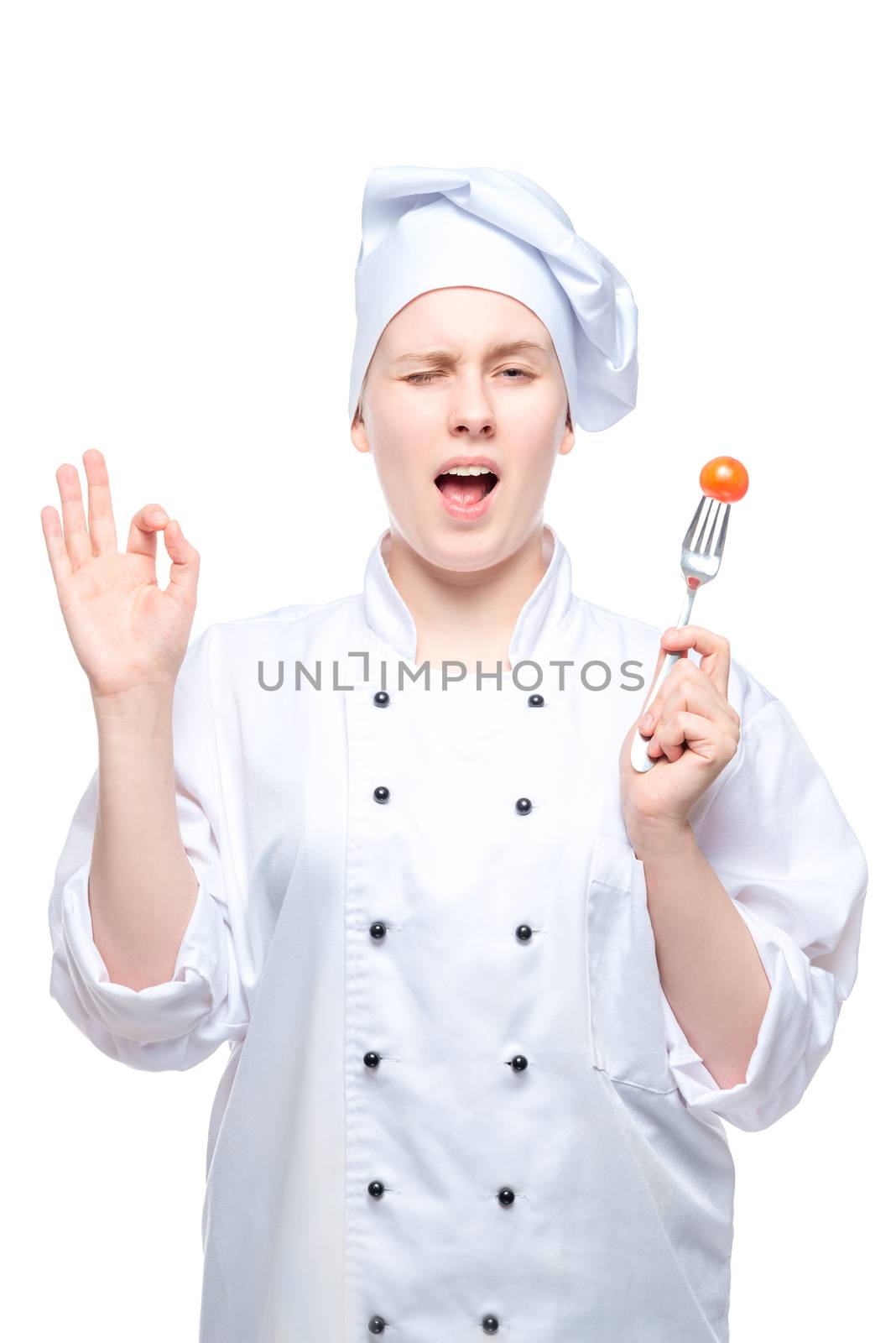chef in a cap with tomato on a fork shows a hand gesture on a wh by kosmsos111