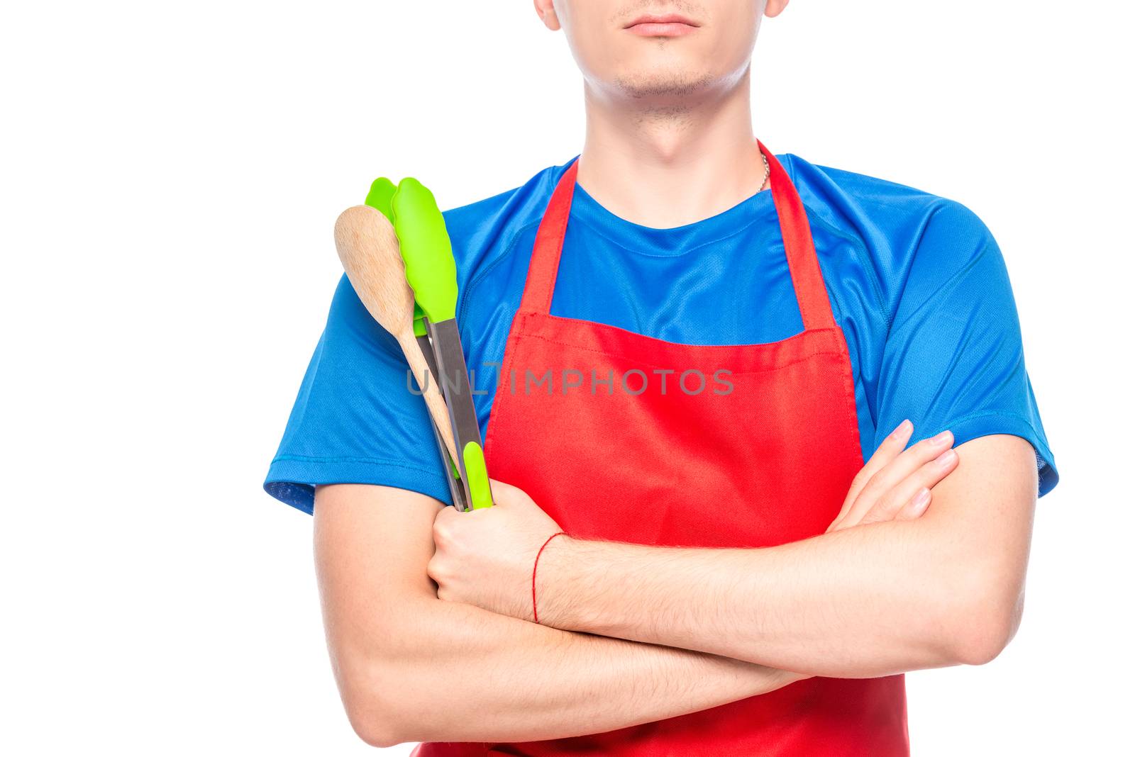 Male chest in apron with kitchen utensils close up isolated