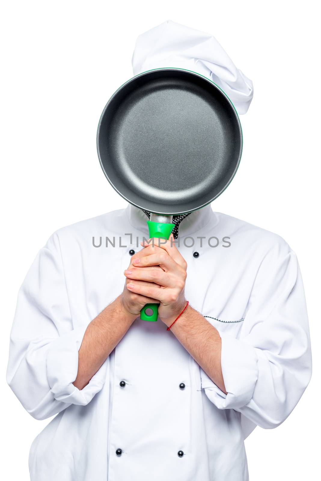 Chef hides his face behind the pan, the portrait is isolated