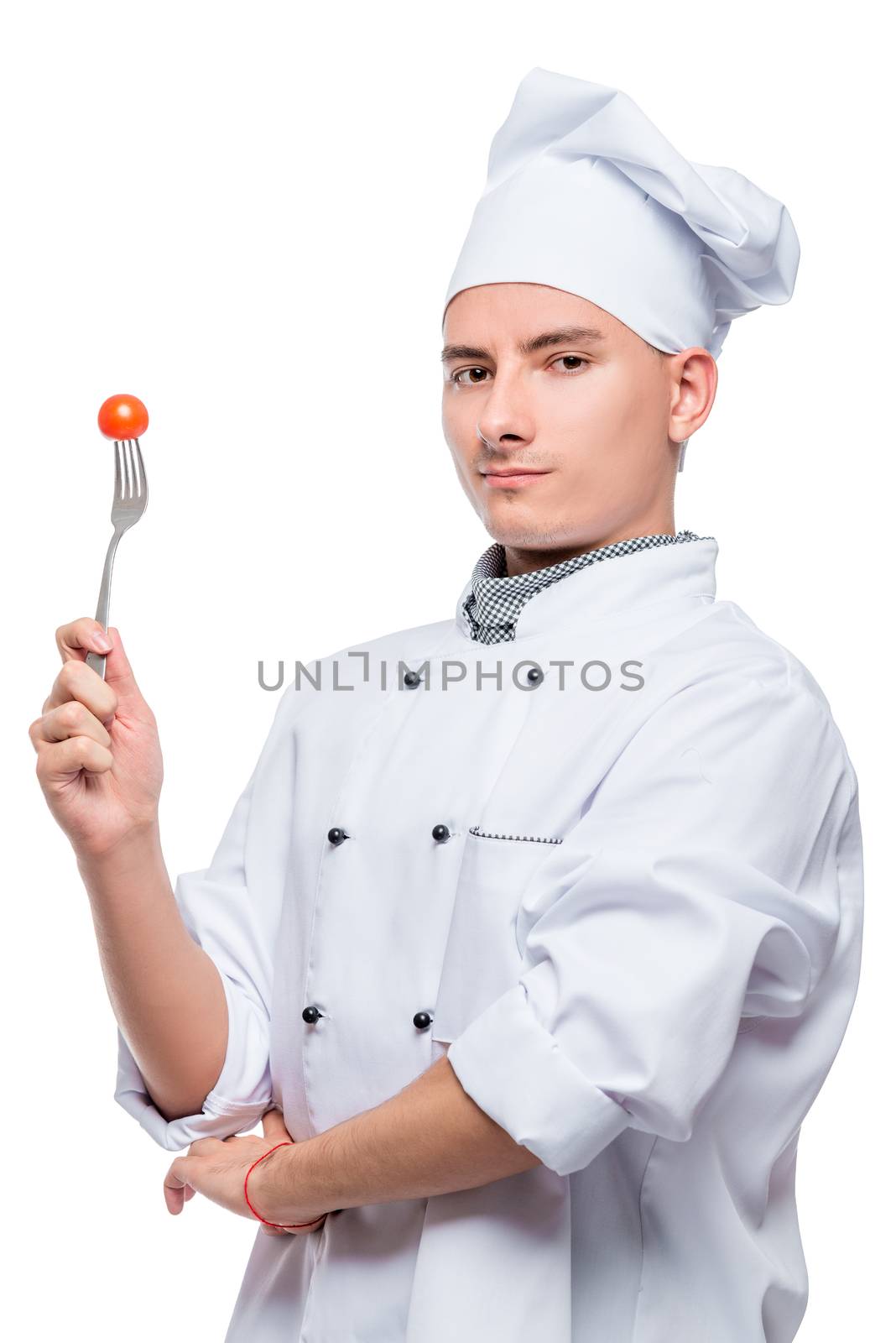 portrait of a successful professional cook with a cherry tomato on a fork, shot on a white background in the studio