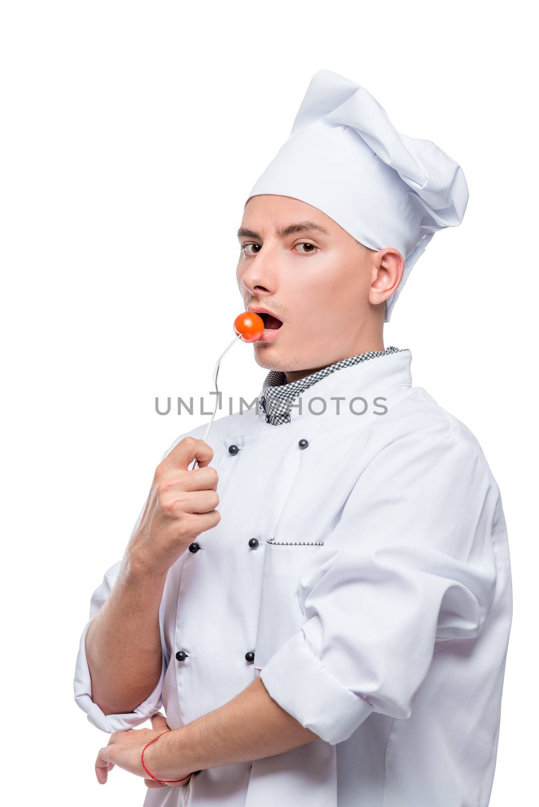 professional chef with cherry tomato on a fork, shot on a white background in the studio