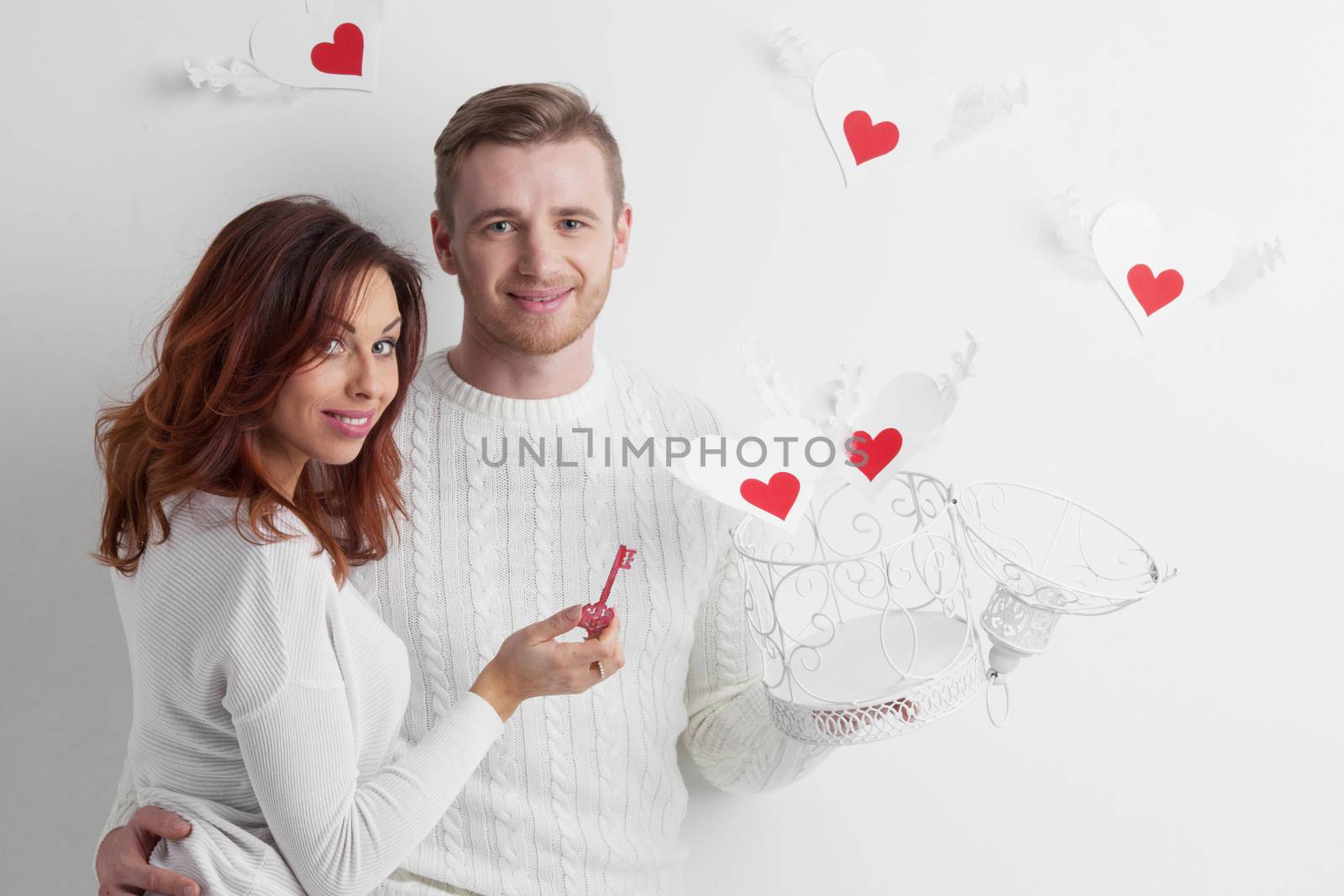 Couple releasing love, man and woman open cage with winged hearts, valentines day concept