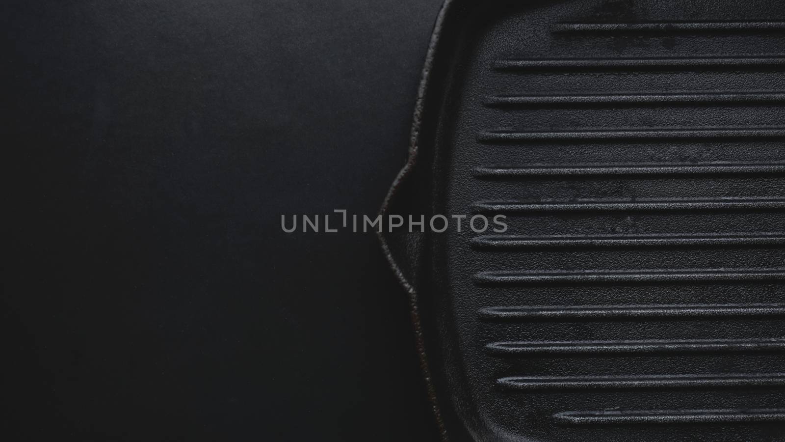 Cast iron griddle pan on black background. Copy space photography.