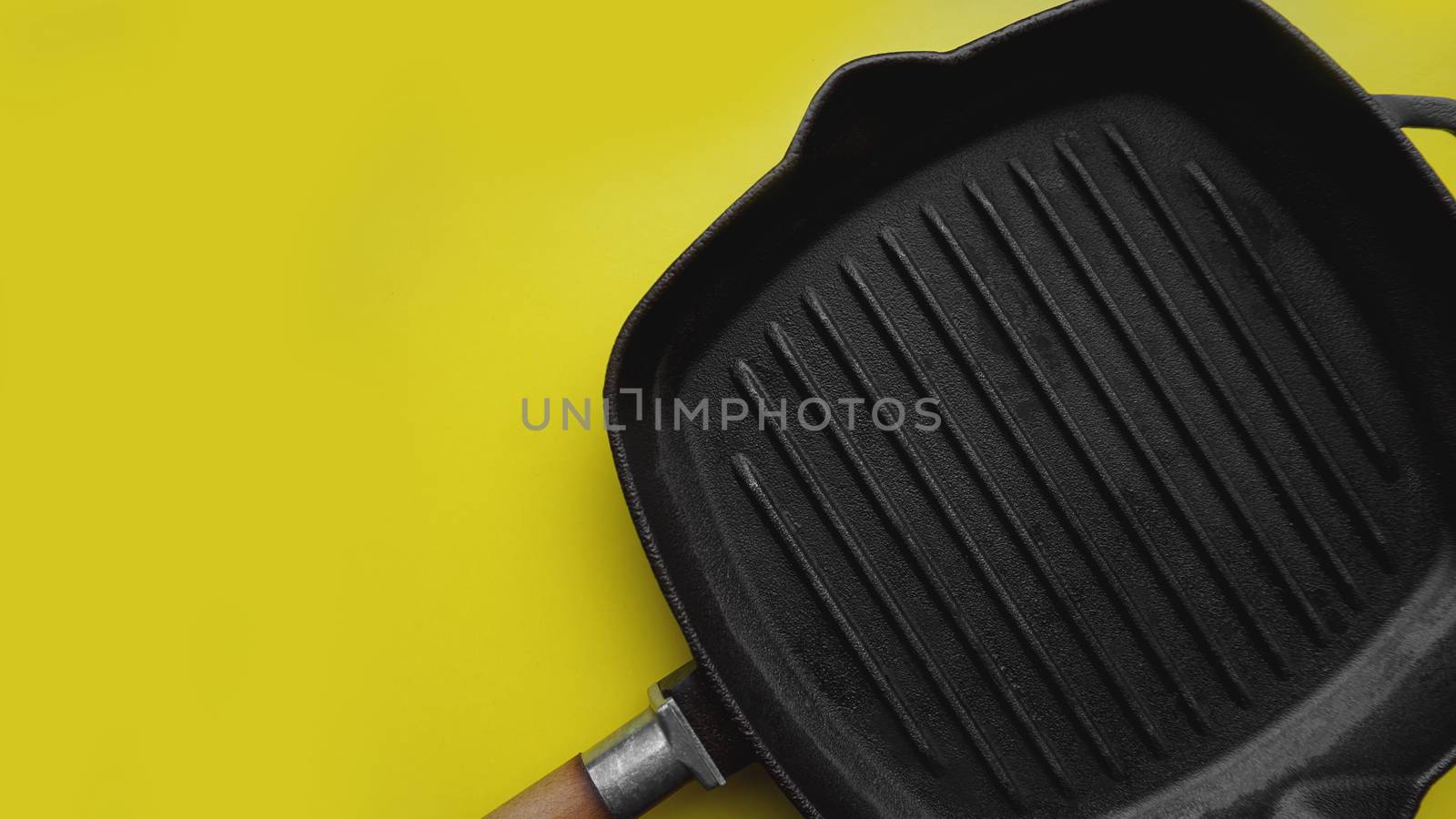 Empty baking tray. View from above on yellow background. Copy space photography.