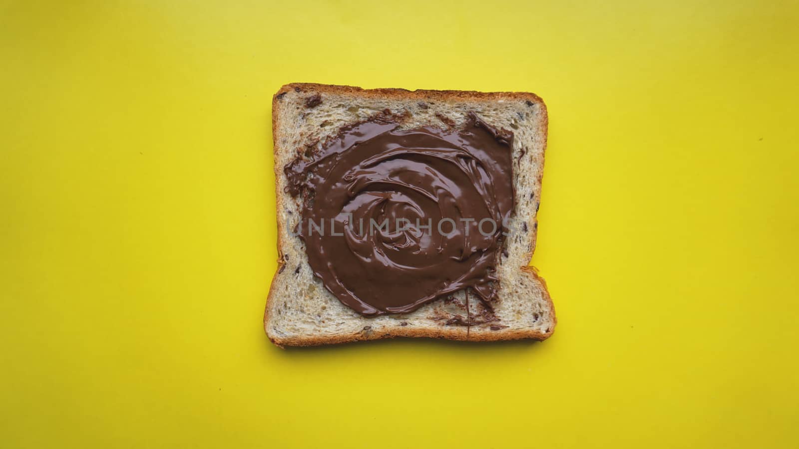 Toast on yellow background - sandwich with chocolate spread. Background for breakfast. View from above - Copy space photography.