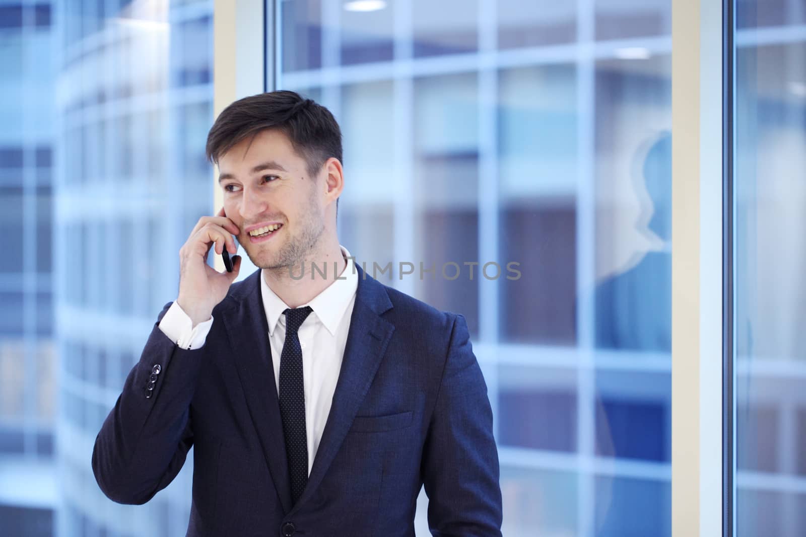 Businessman talking on the phone in office building