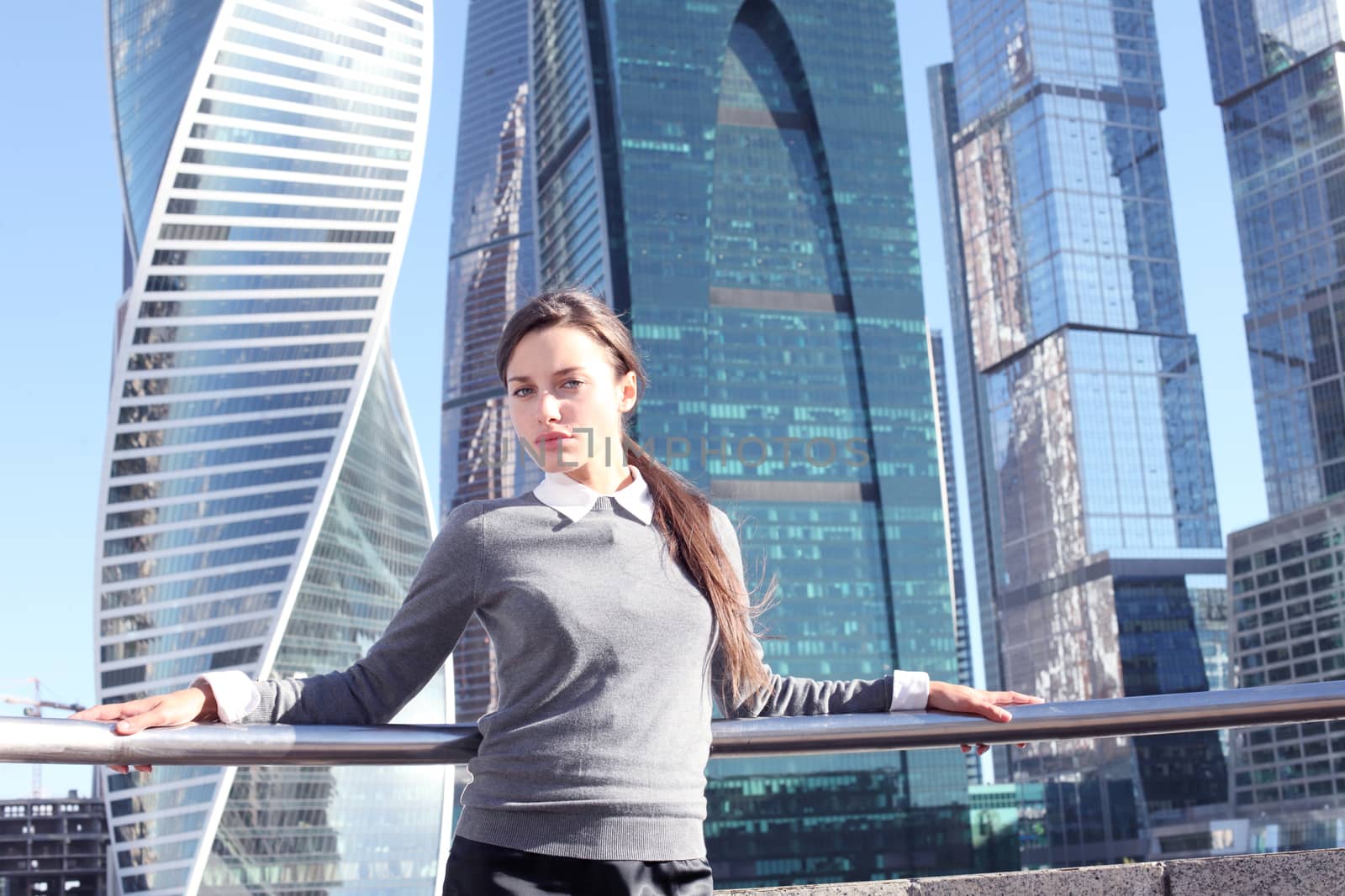 Businesswoman at skyscraper background by ALotOfPeople