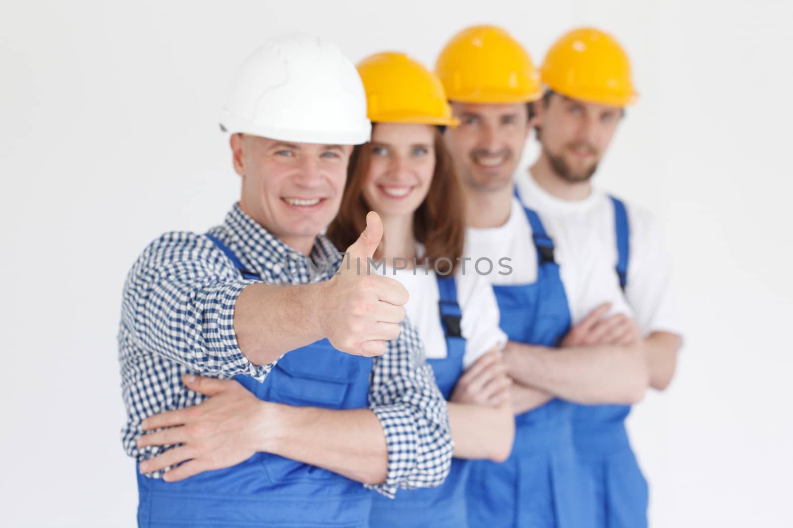 Group portrait of construction workers standing in a row and smiling