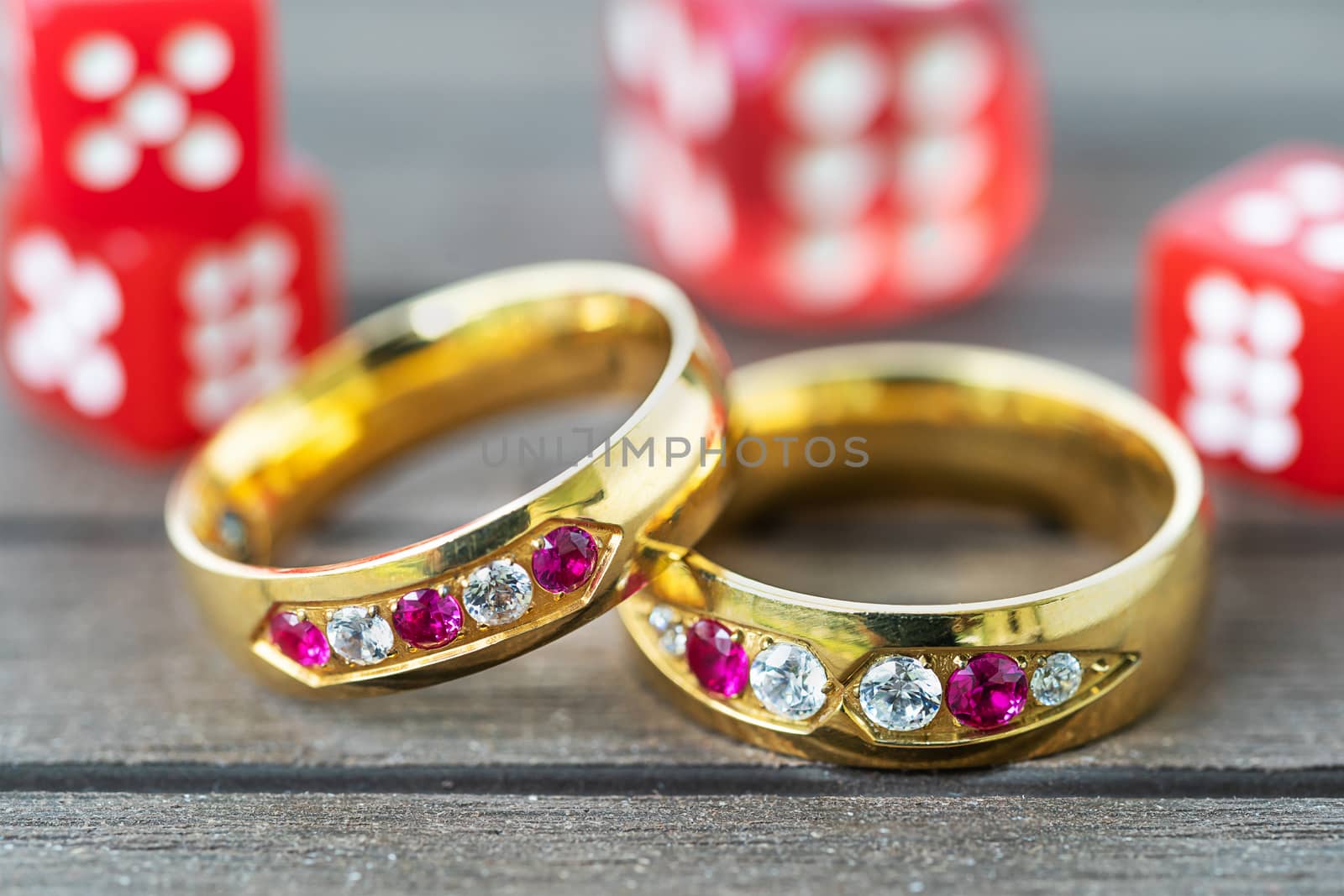Close up shot wedding rings with red dice