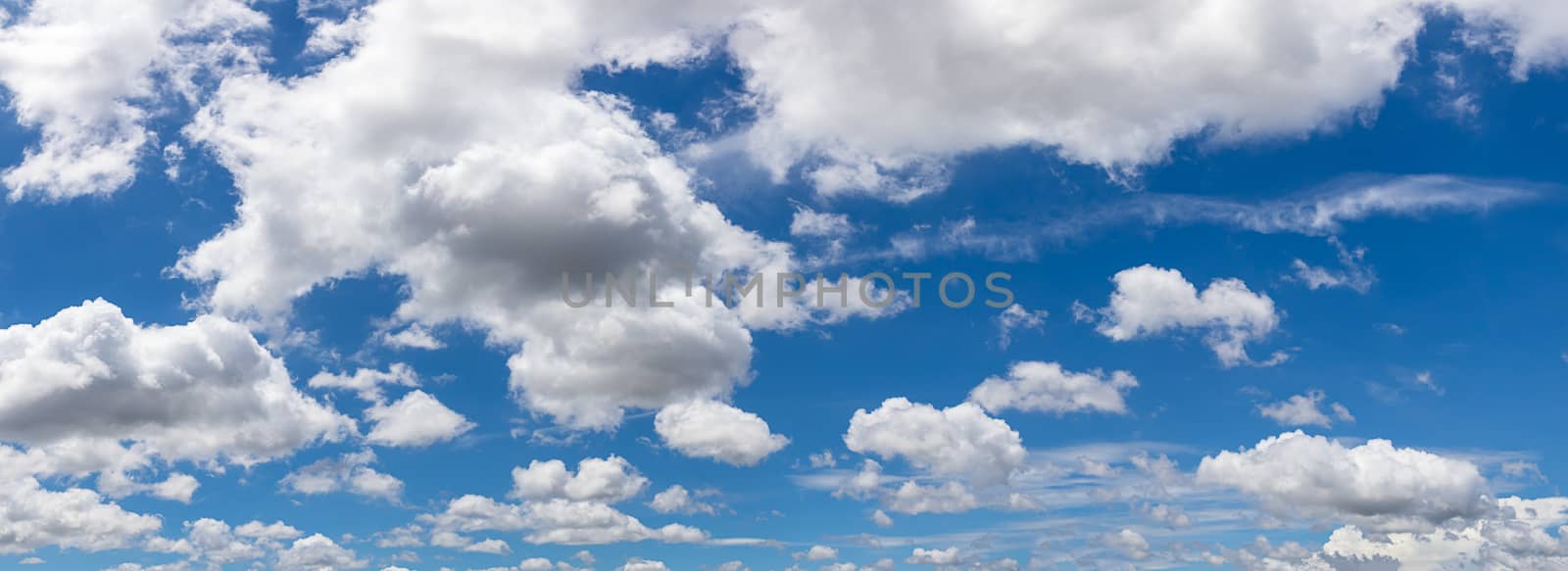 Panoramic white fluffy clouds in the blue sky, Fantastic soft white clouds against blue sky