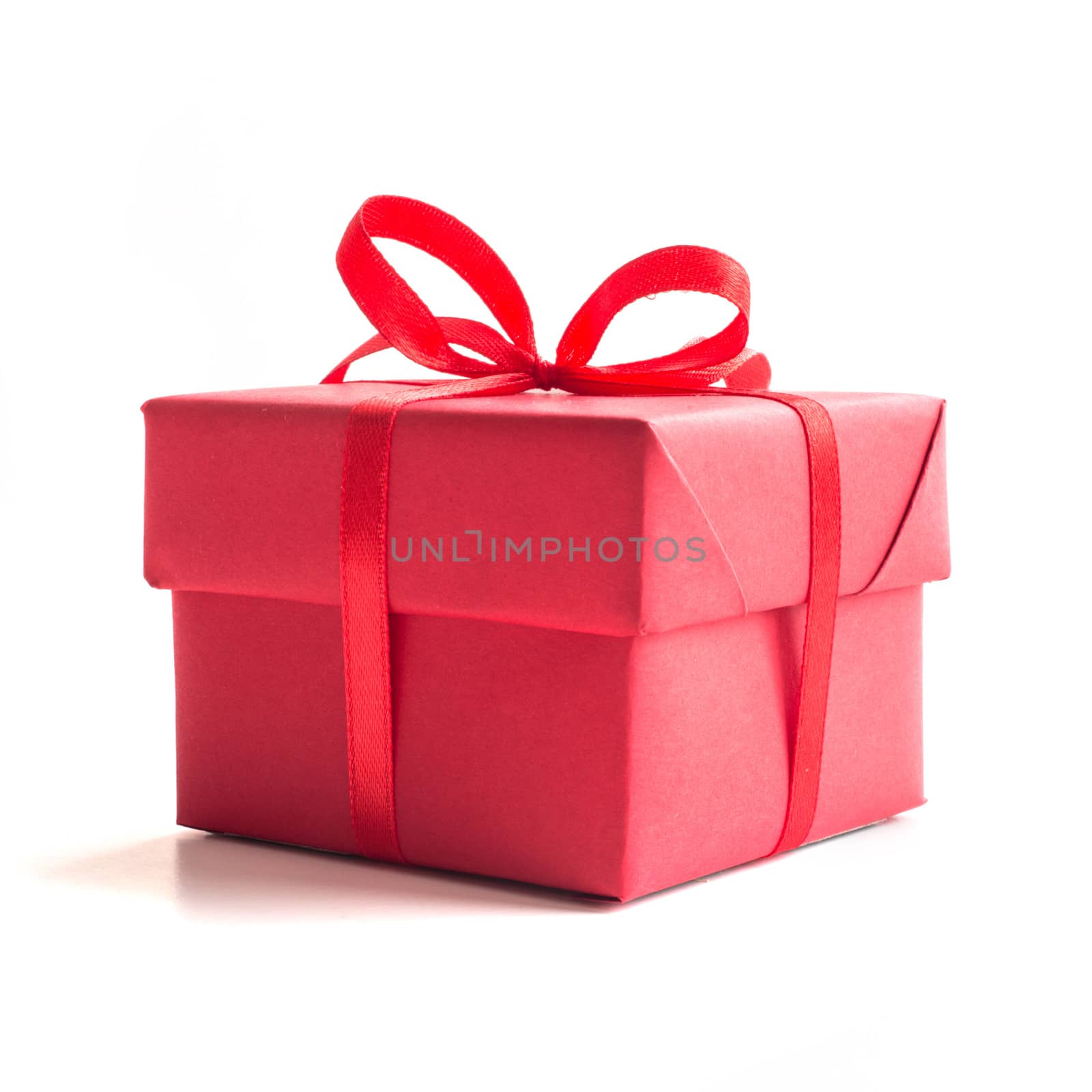 Red gift box with ribbon bow studio isolated on white background Christmas New Year birthday Valentines day anniversary concept