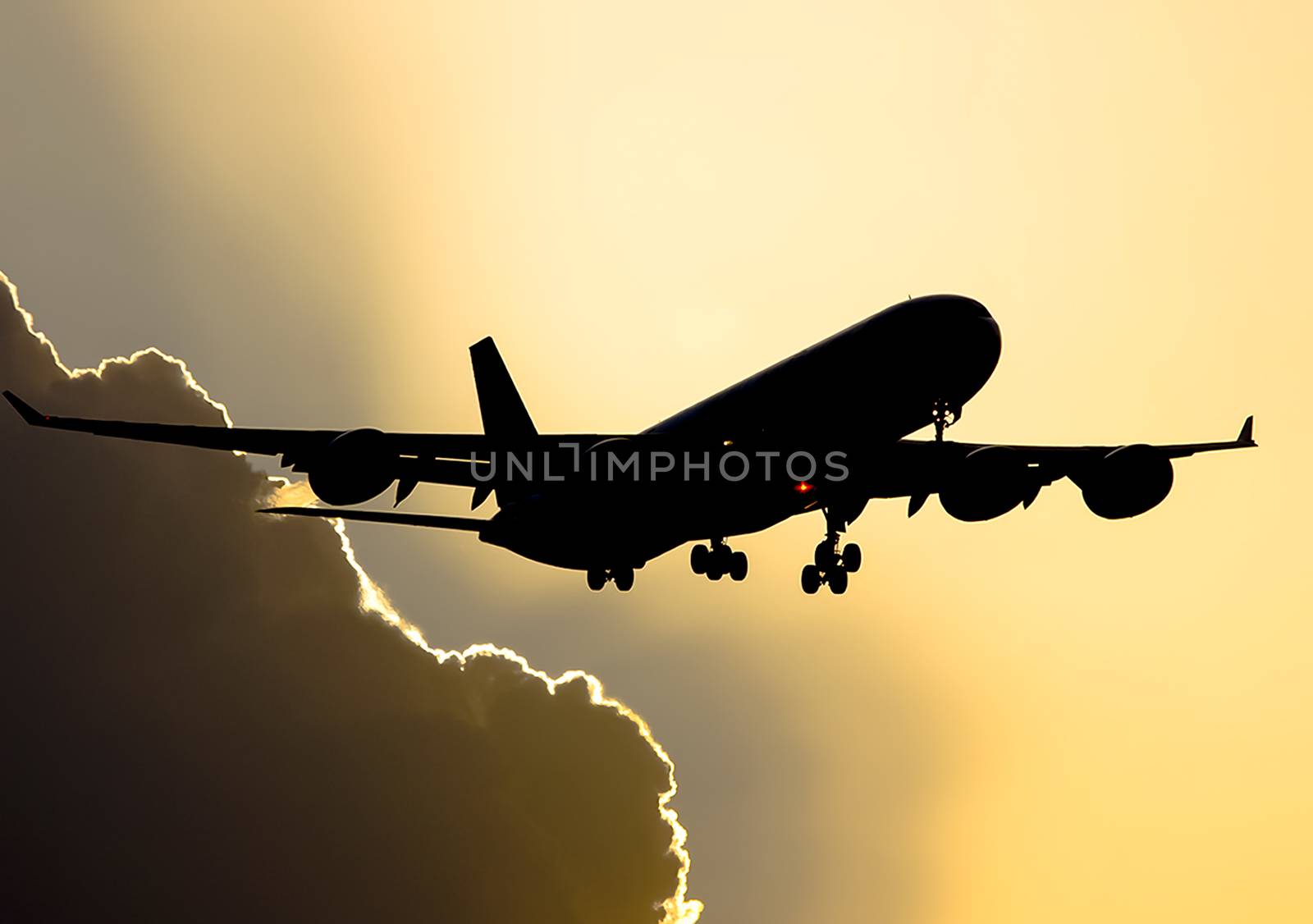 Takeoff of a passenger plane on the background of a sunset. Flight of the air liner at sunset.