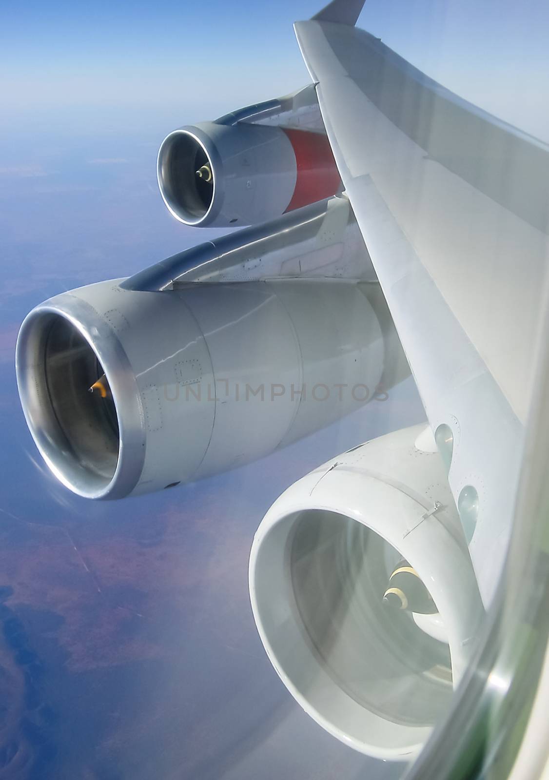 The view from the window of a passenger plane during the flight, the wing of the turbine engine of the aircraft.